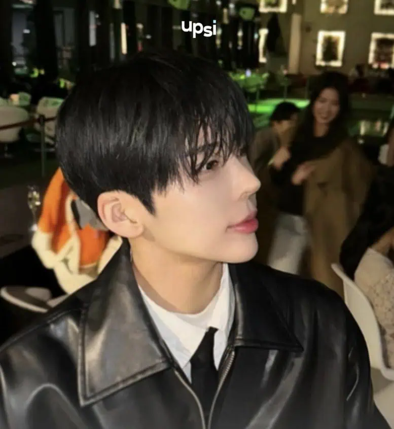 A side view image of Min Seo-gong sitting in a bar-like setting, emphasizing her overly prominent nose bridge and narrow nostrils.